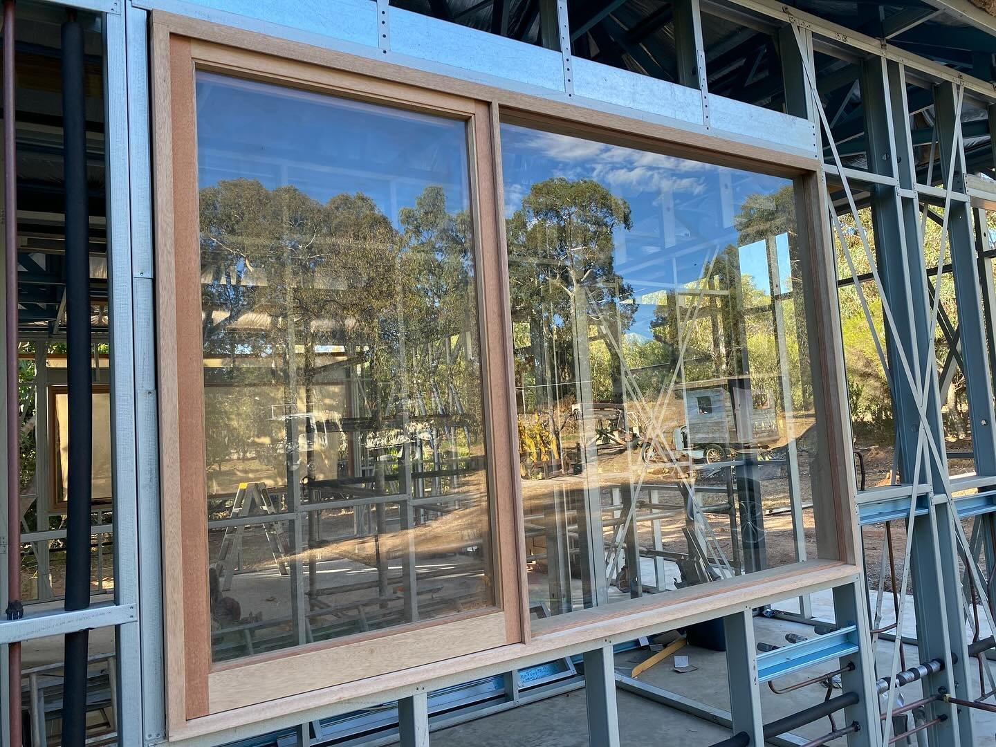 Timber-framed double sliding window installed in a steel-framed home under construction