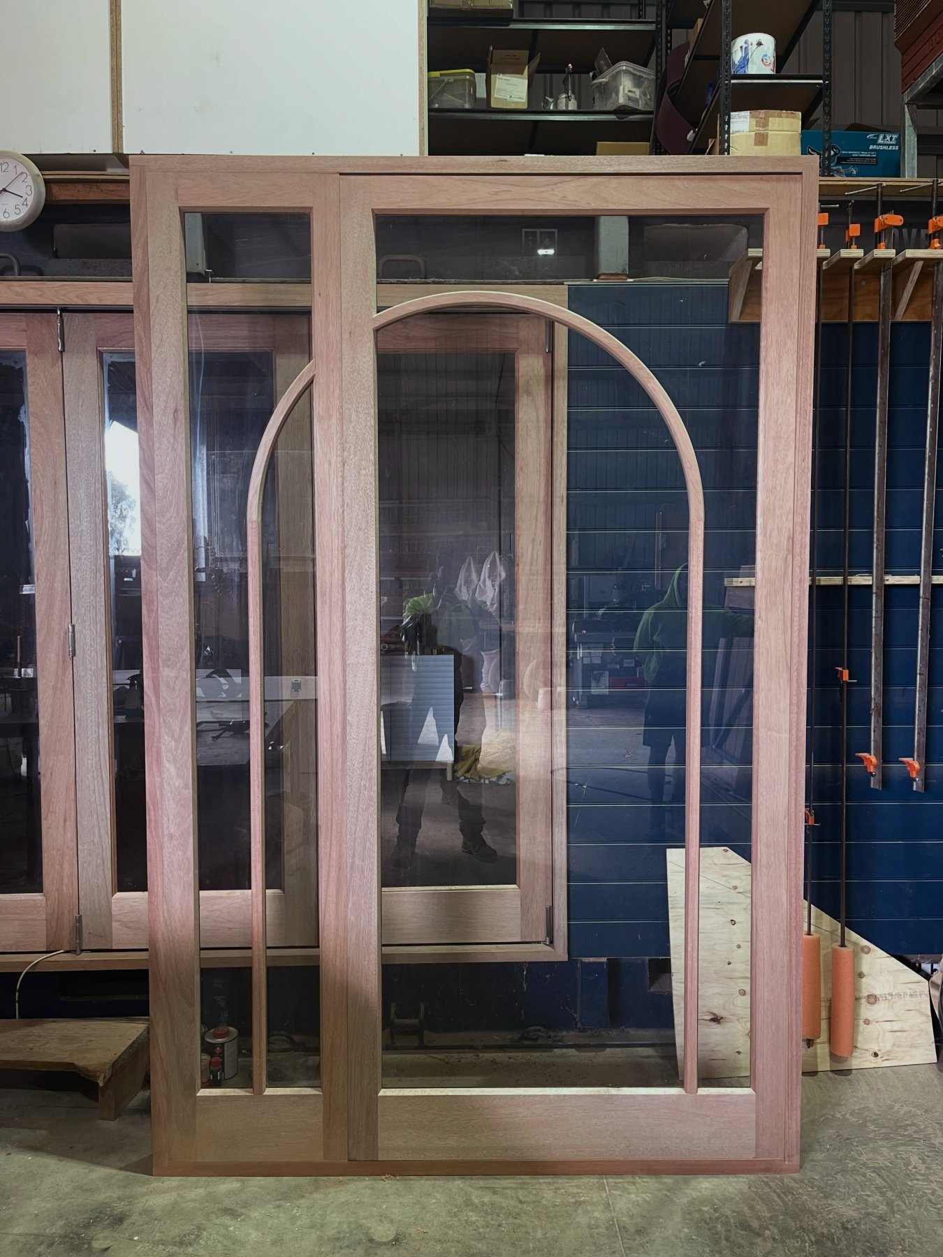 Arched timber double doors with glazed panels, unfinished in the workshop