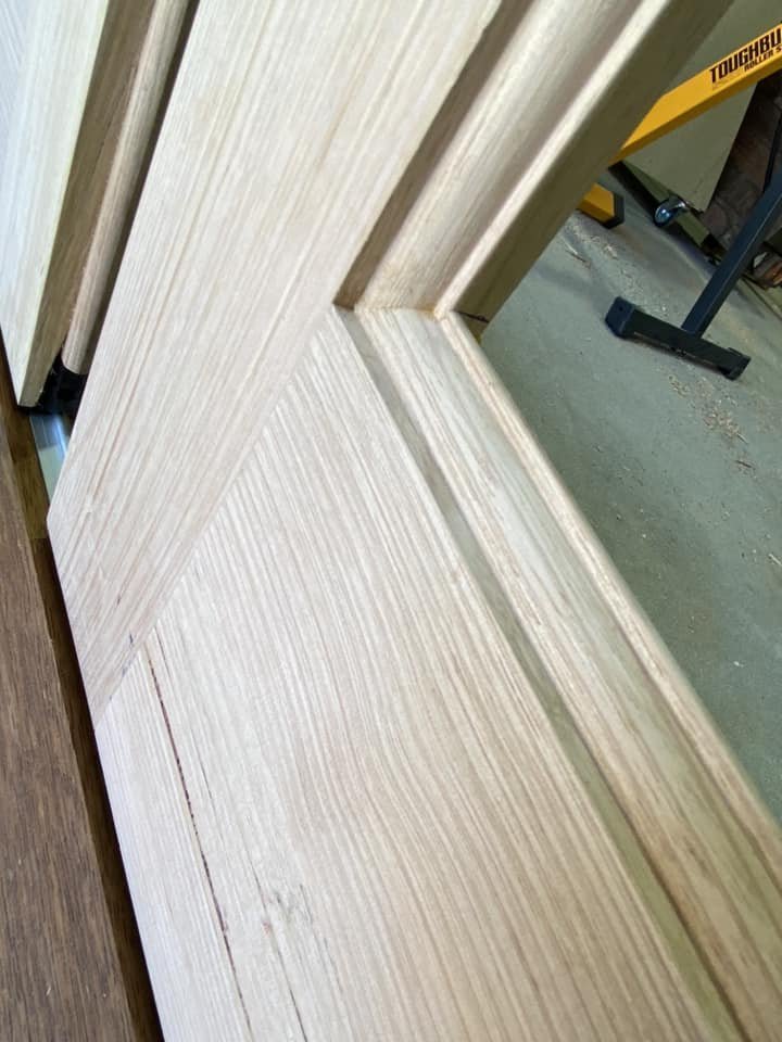 Close-up of timber bifold door panel joinery and edge detailing in the workshop