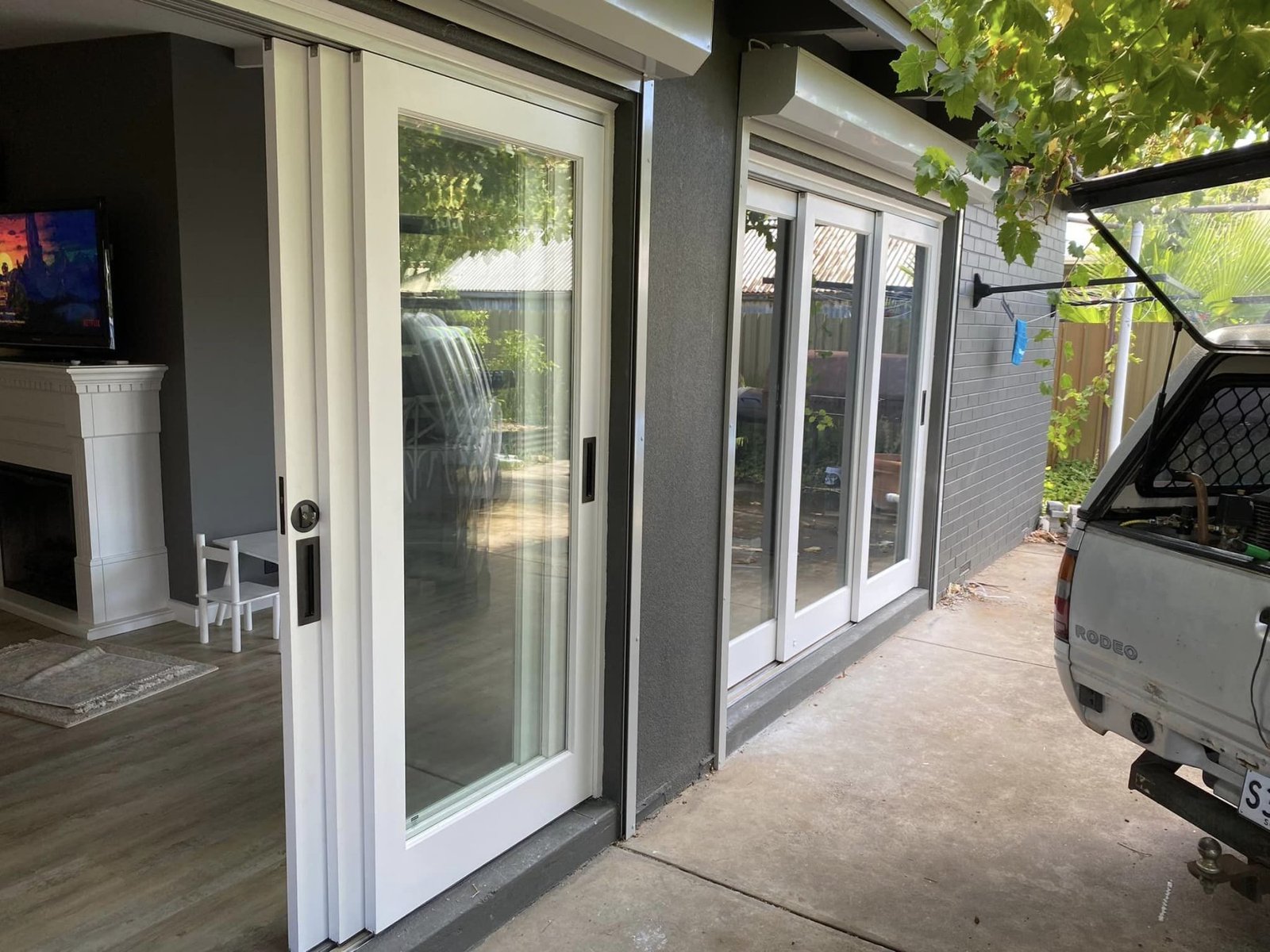 Multi-panel sliding doors connecting a living room to a covered outdoor patio