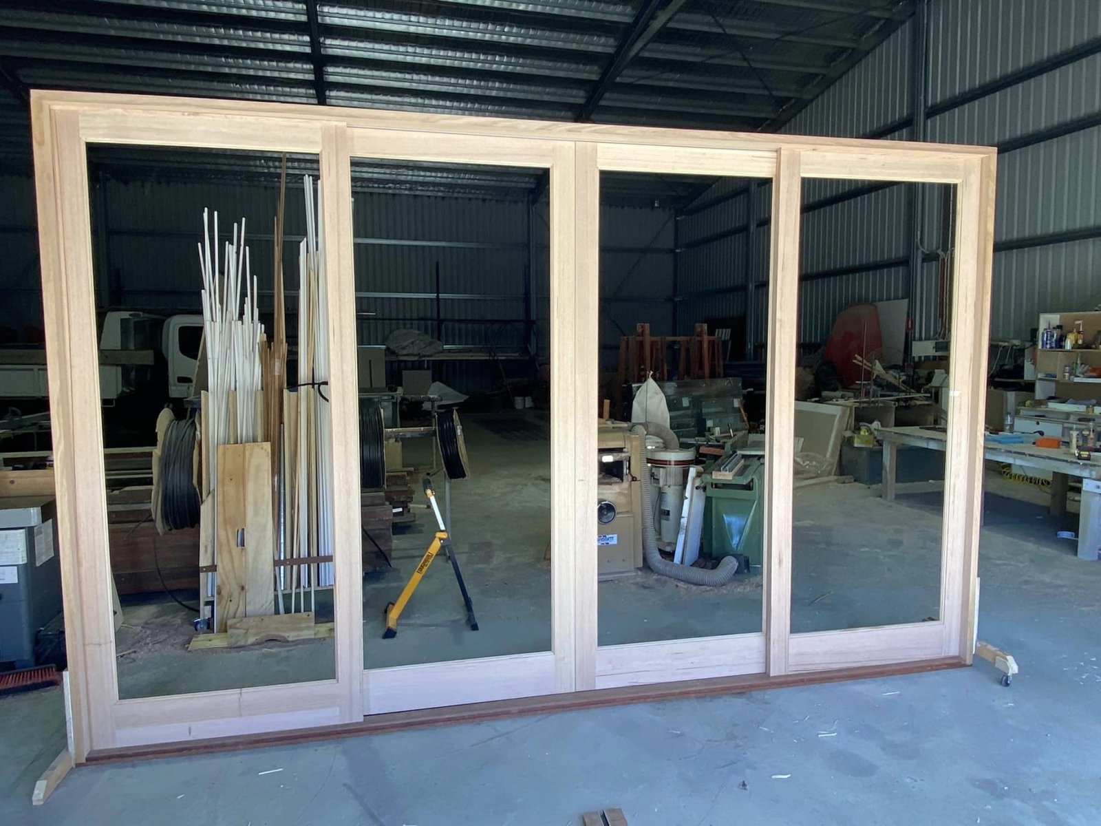 Four-panel timber-framed sliding door unit built in the workshop, ready for glazing